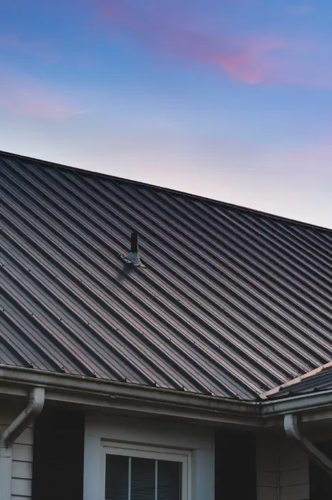 a beautiful house metal roof during the sunset